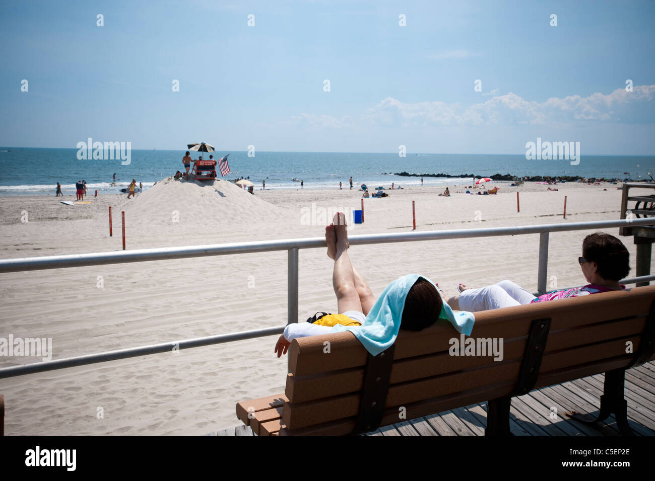 Beachgoers take advantage of the warm summer sun at the beach at the City of Long Beach, Long Island, New York Stock Photo