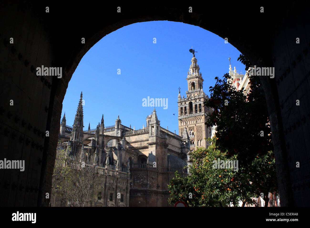 The Cathedral of Seville and its bell tower, known as the Giralda, in Seville, Andalusia, Spain, February 25, 2010. Stock Photo