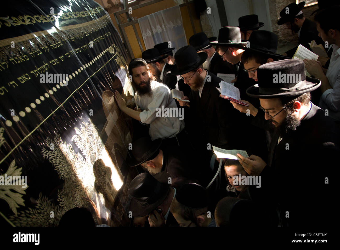 Ultra Orthodox Jewish men pray during 17 Tamuz fast day inside the biblical Tomb of Rachel, Judaism's third holiest shrine, in the West Bank town of Bethlehem on 19 July 2011. The Seventeenth of Tammuz is a fast day of mourning to remember the many tragedies that have befallen the Jewish people over the centuries. Stock Photo