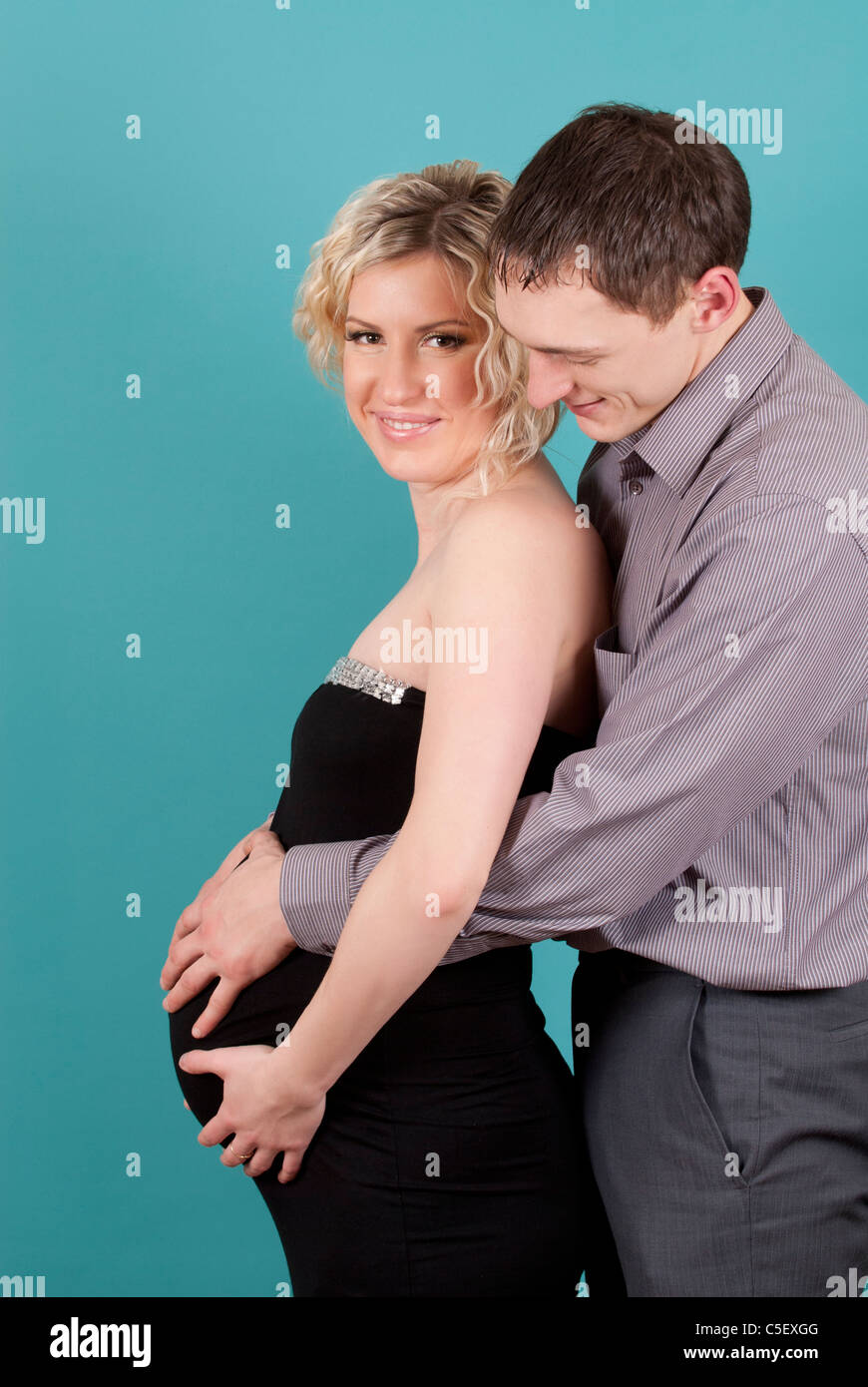 Man hugging pregnant woman Stock Photo - Alamy