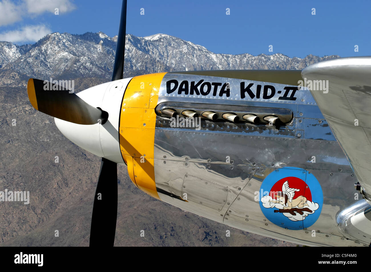 Backed by the San Jacinto Mountain Range the P-51 Mustang 'Dakota Kid II' sits on the ramp at Palm Springs Airport. Stock Photo
