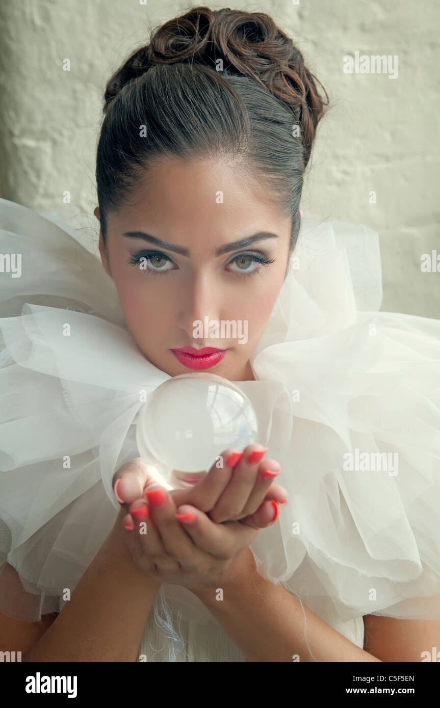 Woman holding a crystal ball Stock Photo - Alamy