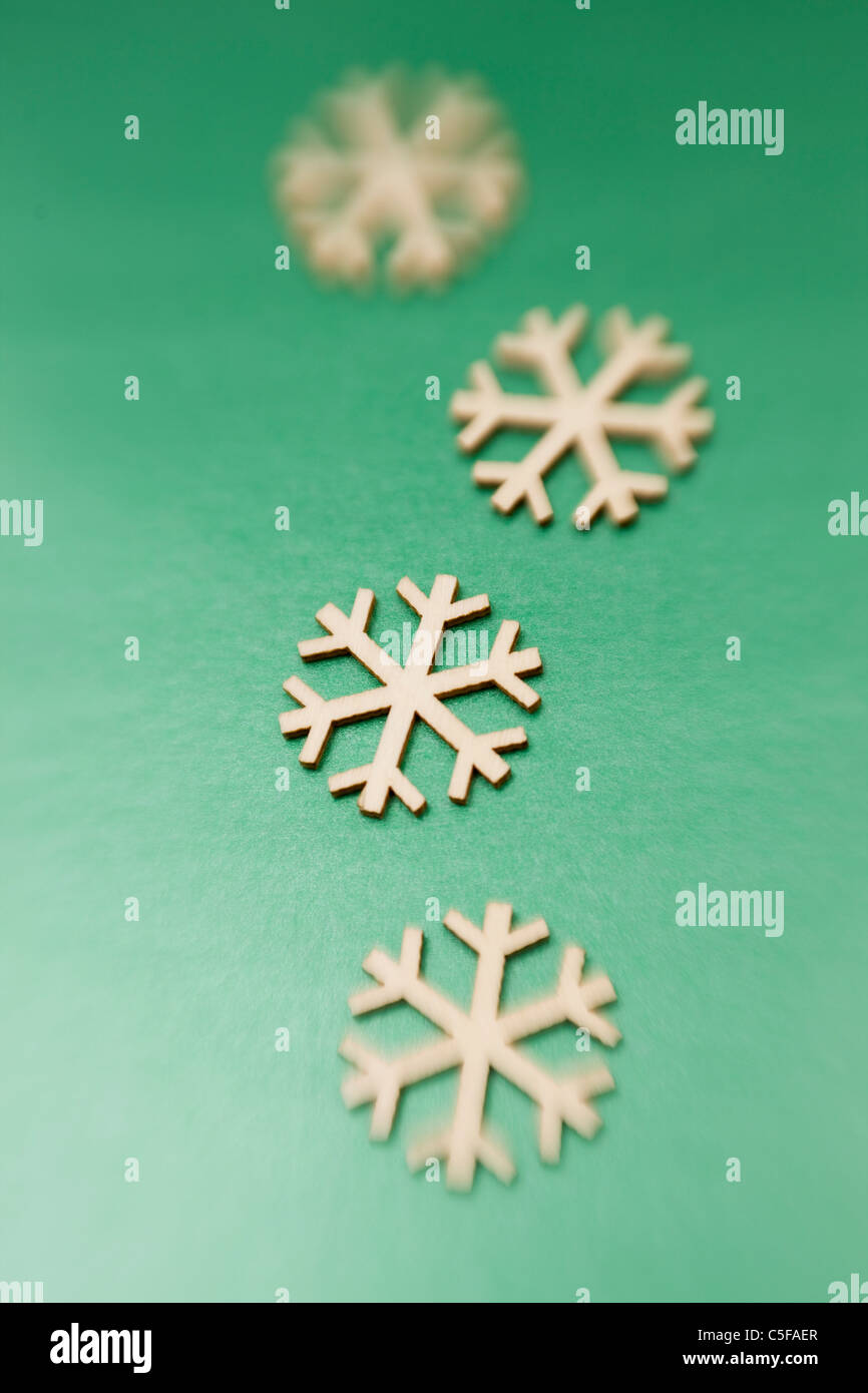 Snowflake ornaments on green background Stock Photo