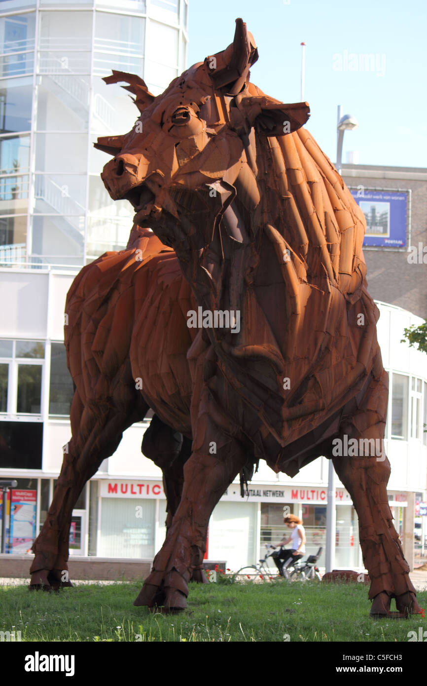 rusty giant iron bull standing in the city Stock Photo