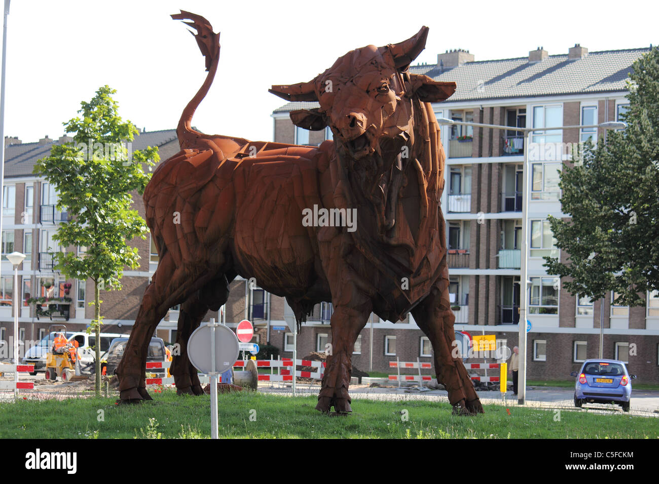 rusty giant iron bull standing in the city Stock Photo