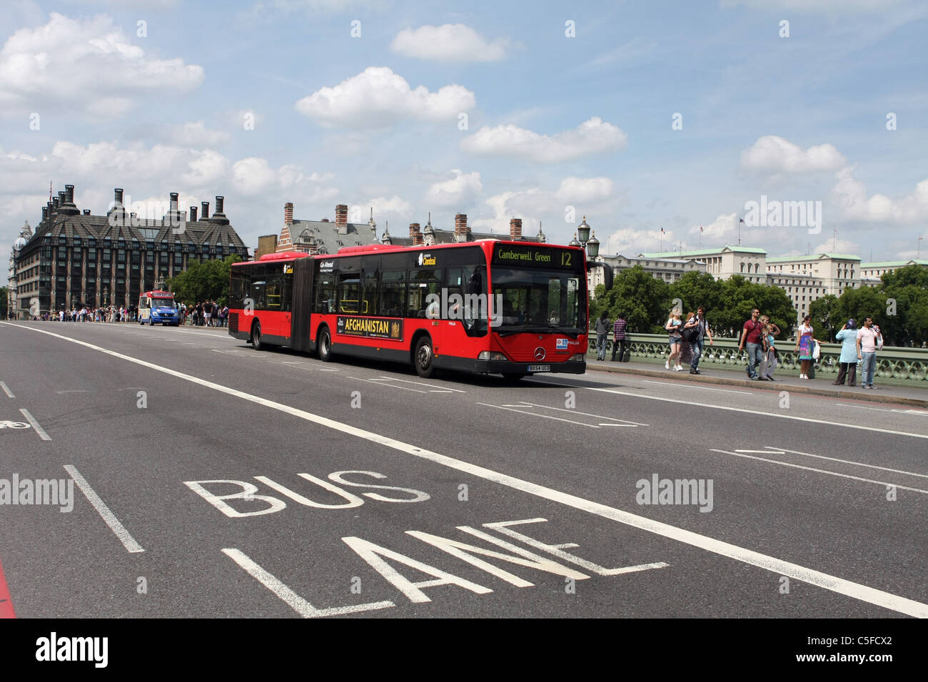 A bendy bus traveling across Westminster Bridge Stock Photo