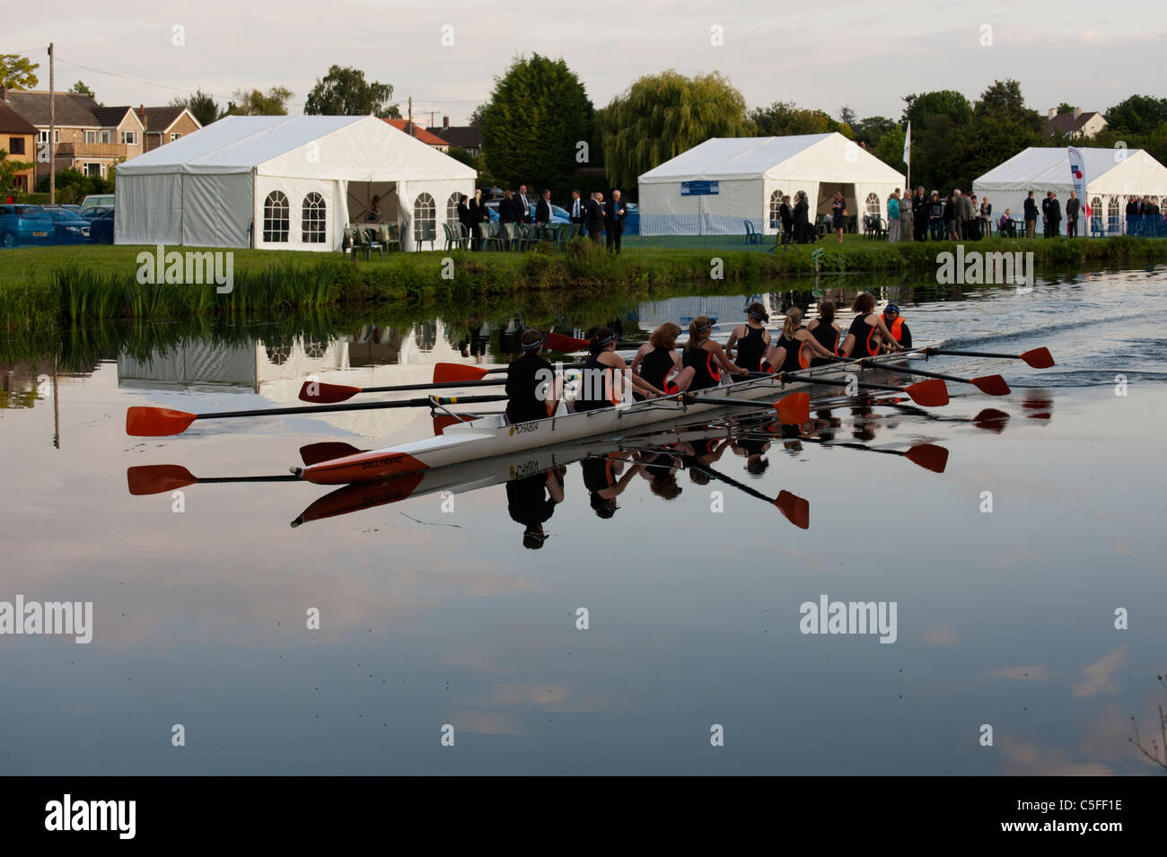 Rowing in the Cambridge Bumps. A boat glides through almost mirror like
