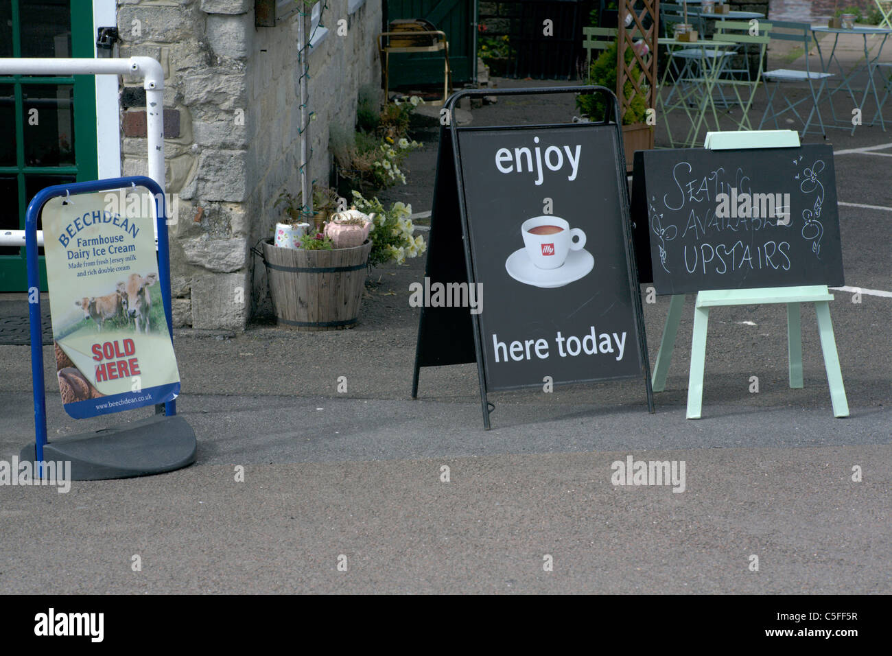 Signs outside a cafe England UK saying seating upstairs Stock Photo