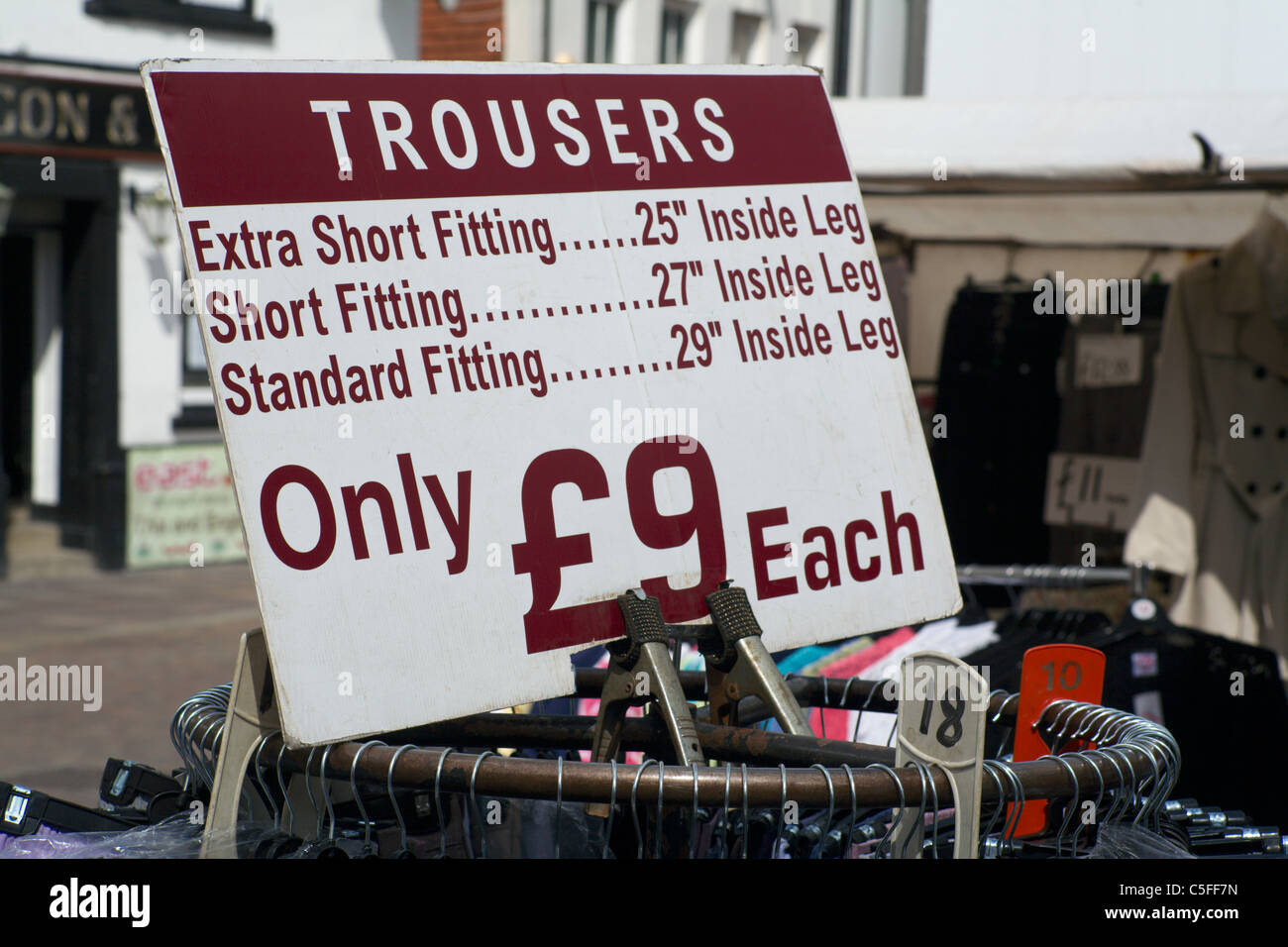Sign showing prices of trousers on sale in market Newbury Berkshire England UK Stock Photo