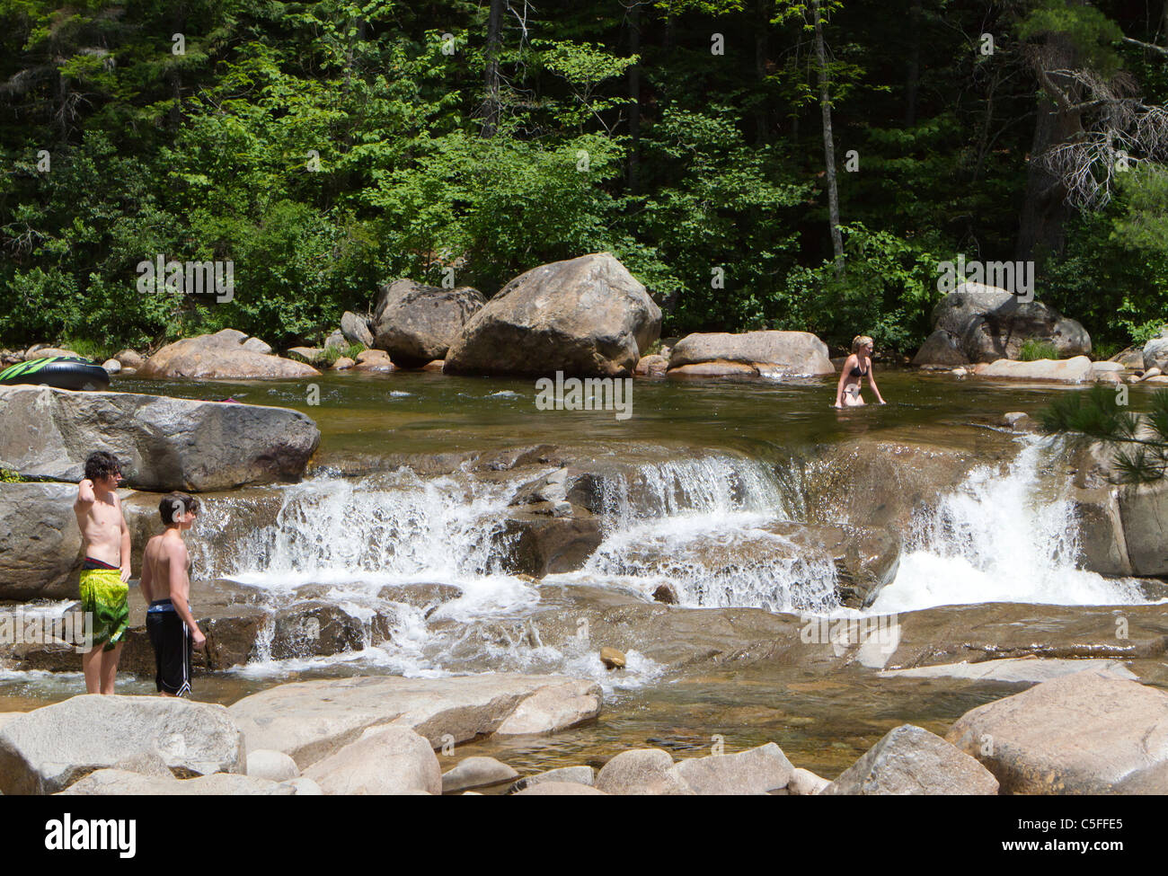 People swimming in a rocky in a river in the United States