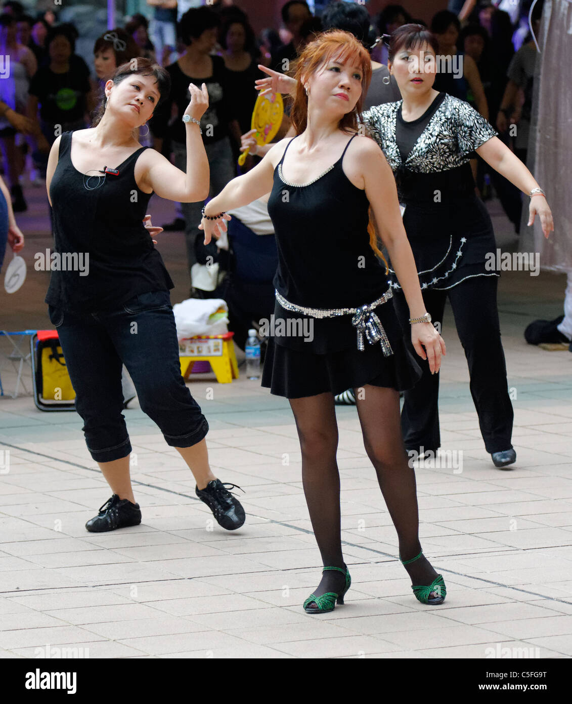 Line dancers to Country Music on Orchard Road, Singapore Stock Photo