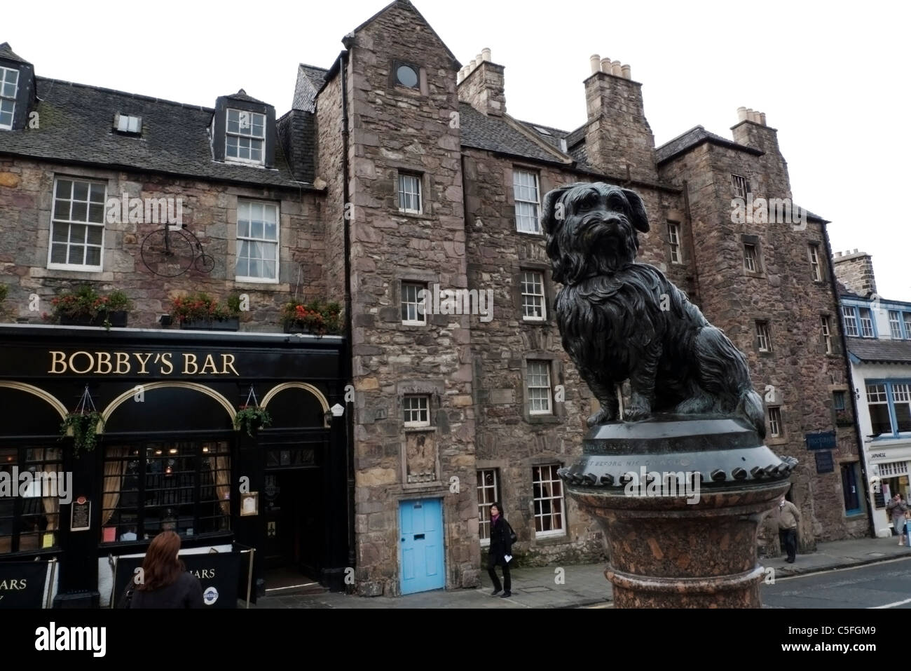 Statue of famous Scottie dog Bobby and Bobby's Bar Edinburgh Greyfriars