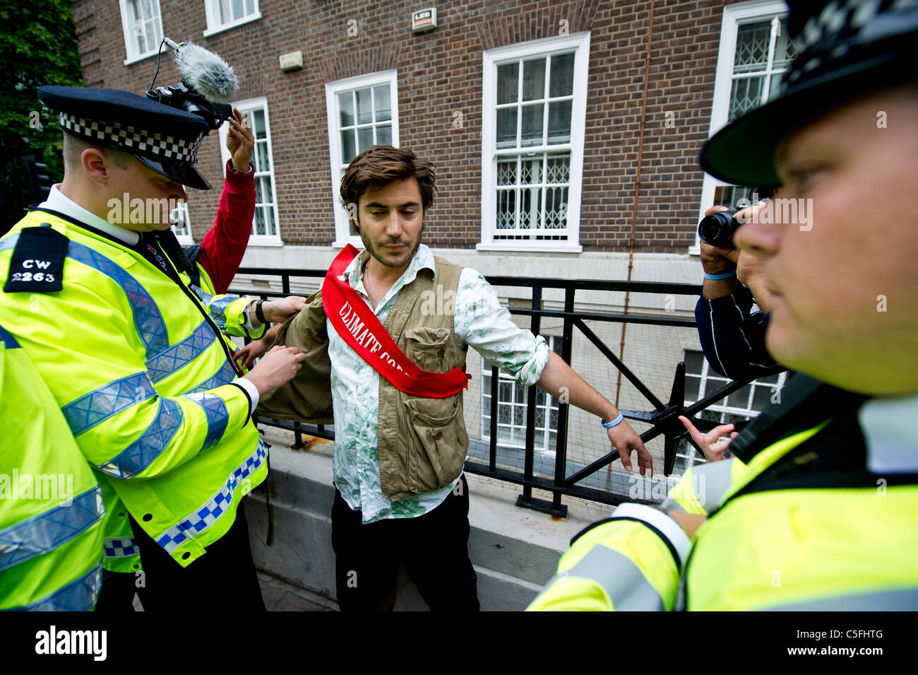 Police search and question a Climate Rush protestor against the 4000 deaths caused by poor air quality in London each year. Stock Photo