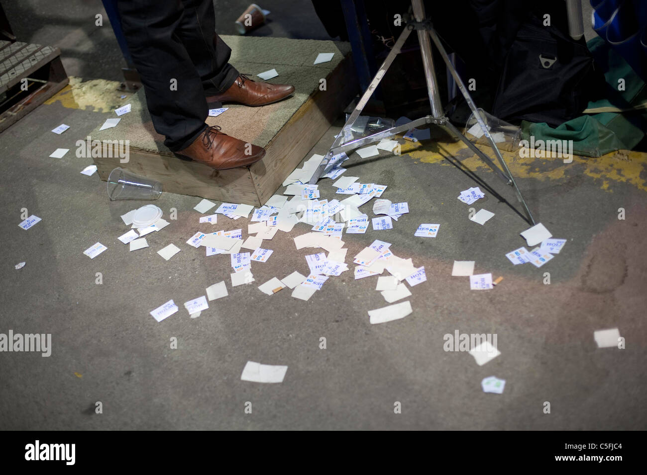 Disused betting slips at the feet of a bookmaker Stock Photo