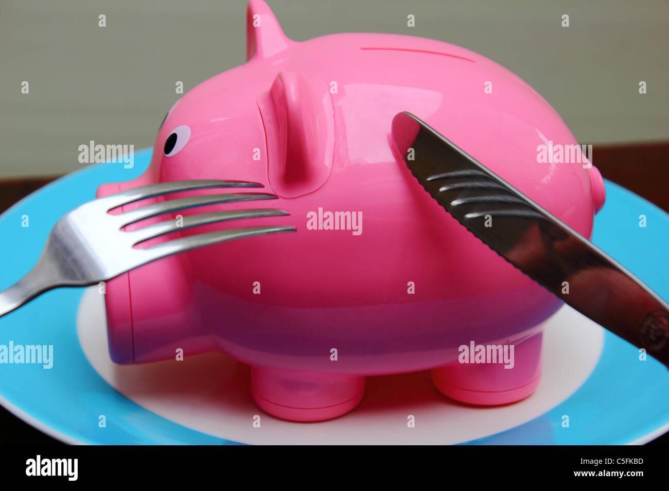 A Piggy Bank On A Plate Ready To Been Eaten Conceptual Image