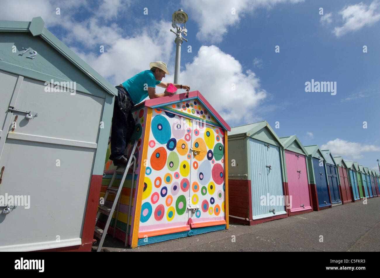 A rebel beach hut owner decides to be different and defy the rules about regulation paint colours. Stock Photo