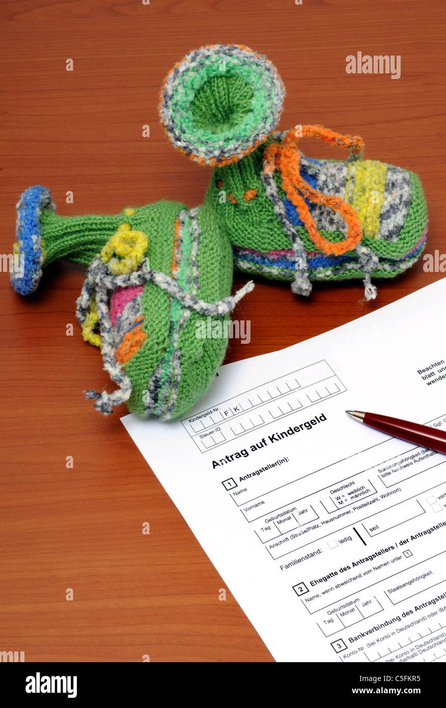Application Form For Family Credit With Bootees And Ballpoint Pen