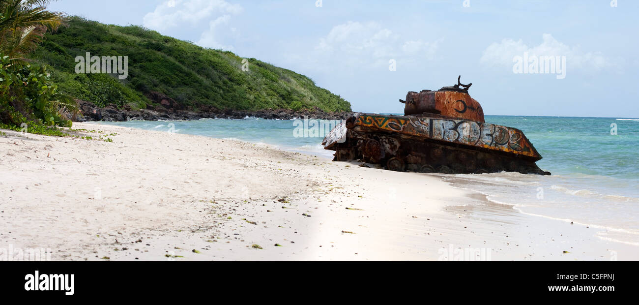 An old rusted and deserted army tank of Flamenco beach on the Puerto Rican island of Culebra. Paradise lost. Stock Photo