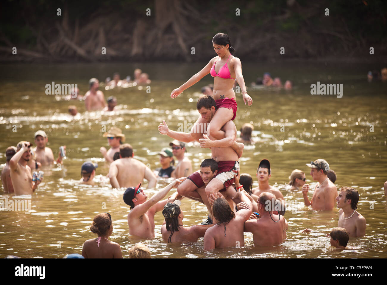 People take a break from the heat in the Oconee River during the annual