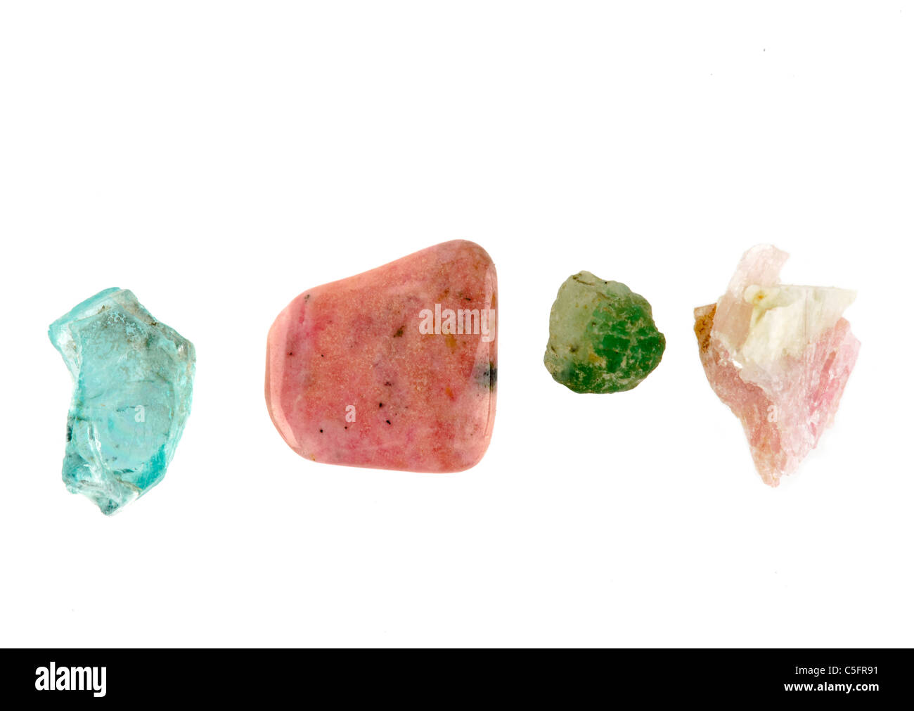 Four rock specimens all from Madagascar from left to right   Apatite, Rhodonite, Emerald and Rubellite Stock Photo