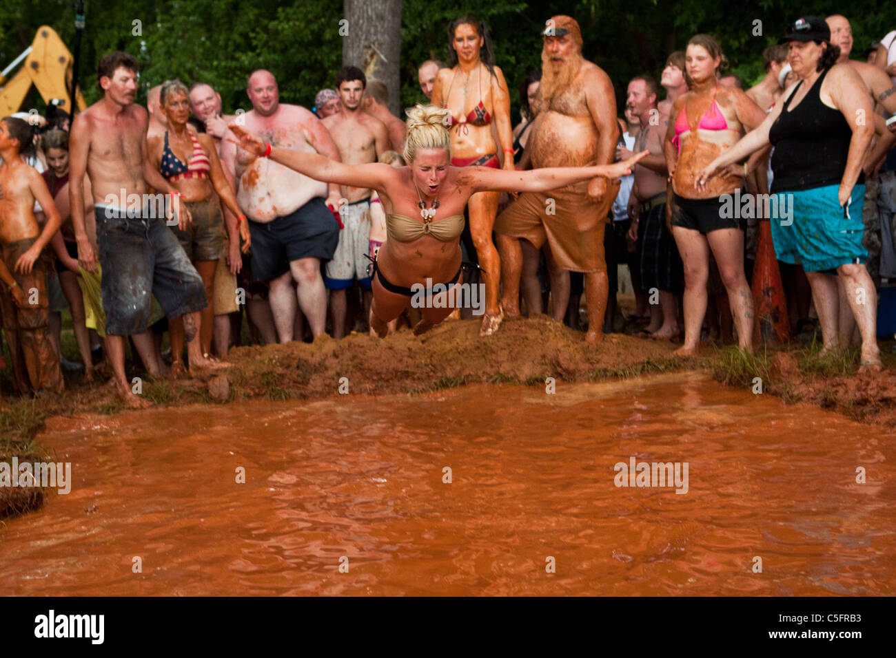 Mud pit belly flop contest during the annual Summer Redneck Games Dublin, GA. Stock Photo