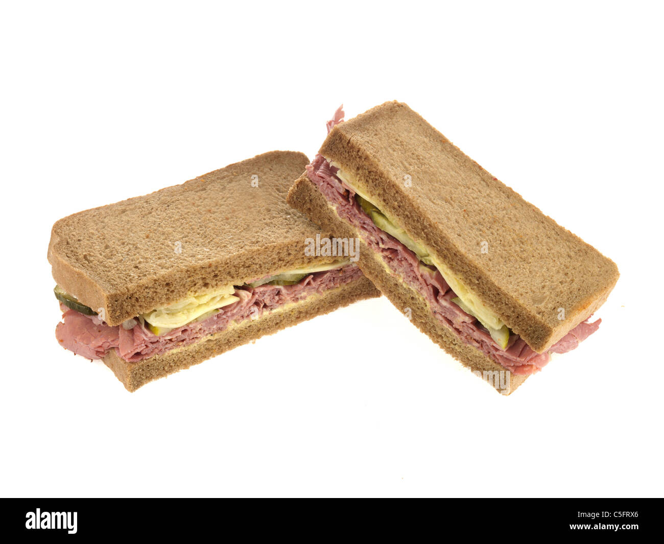 Freshly Cut Pastrami Beef Deli Sandwich In Rye Bread Against A White