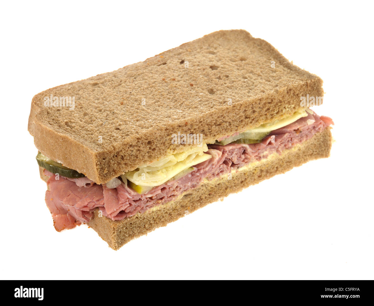 Freshly Cut Pastrami Beef Deli Sandwich In Rye Bread Against A White