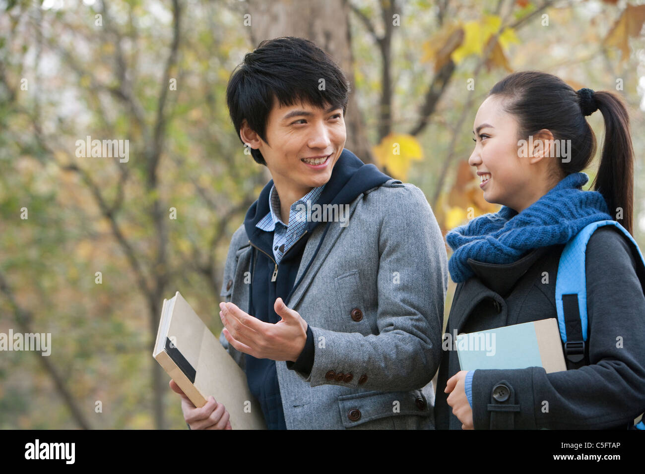 A young man and woman talking together on campus Stock Photo - Alamy