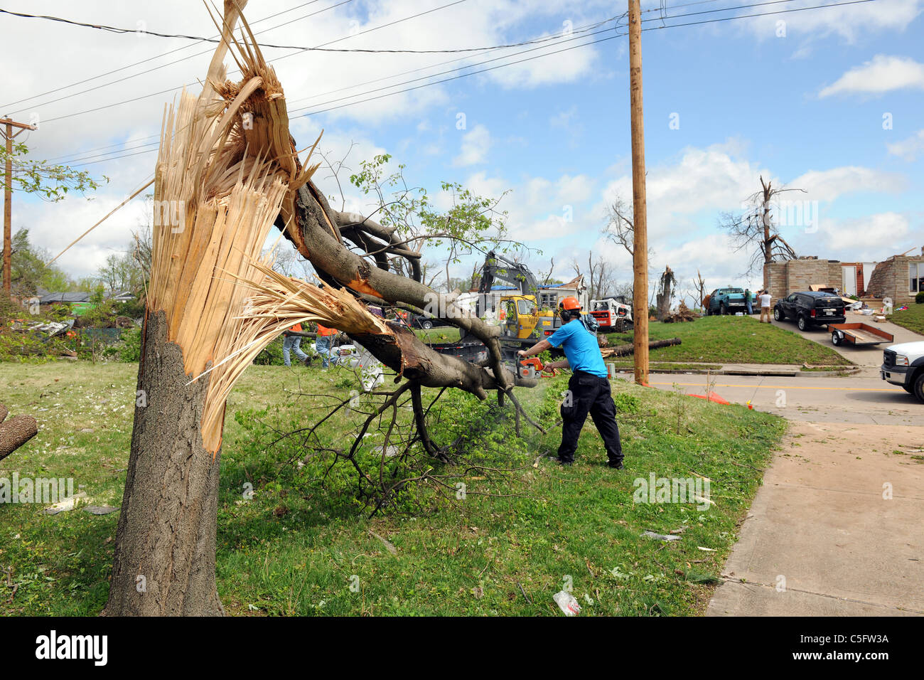 SAINT LOUIS, MISSOURI - APRIL 26: A man cleans up after tornadoes ...
