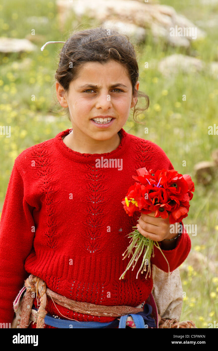 Young girl with red poppies, Eastern Anatolia, Turkey Stock Photo