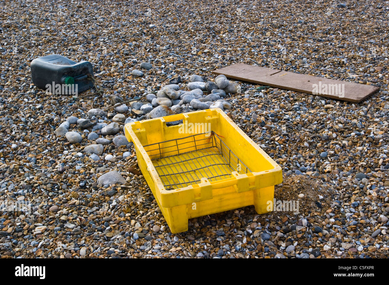 Discarded rubbish on shingle beach uk stock photo alamy