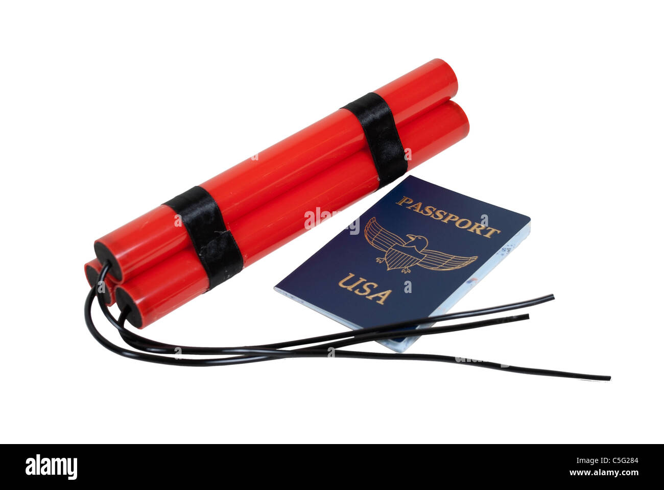 Bundle of red sticks of dynamite with long fuses and a blue passport for travel - path included Stock Photo