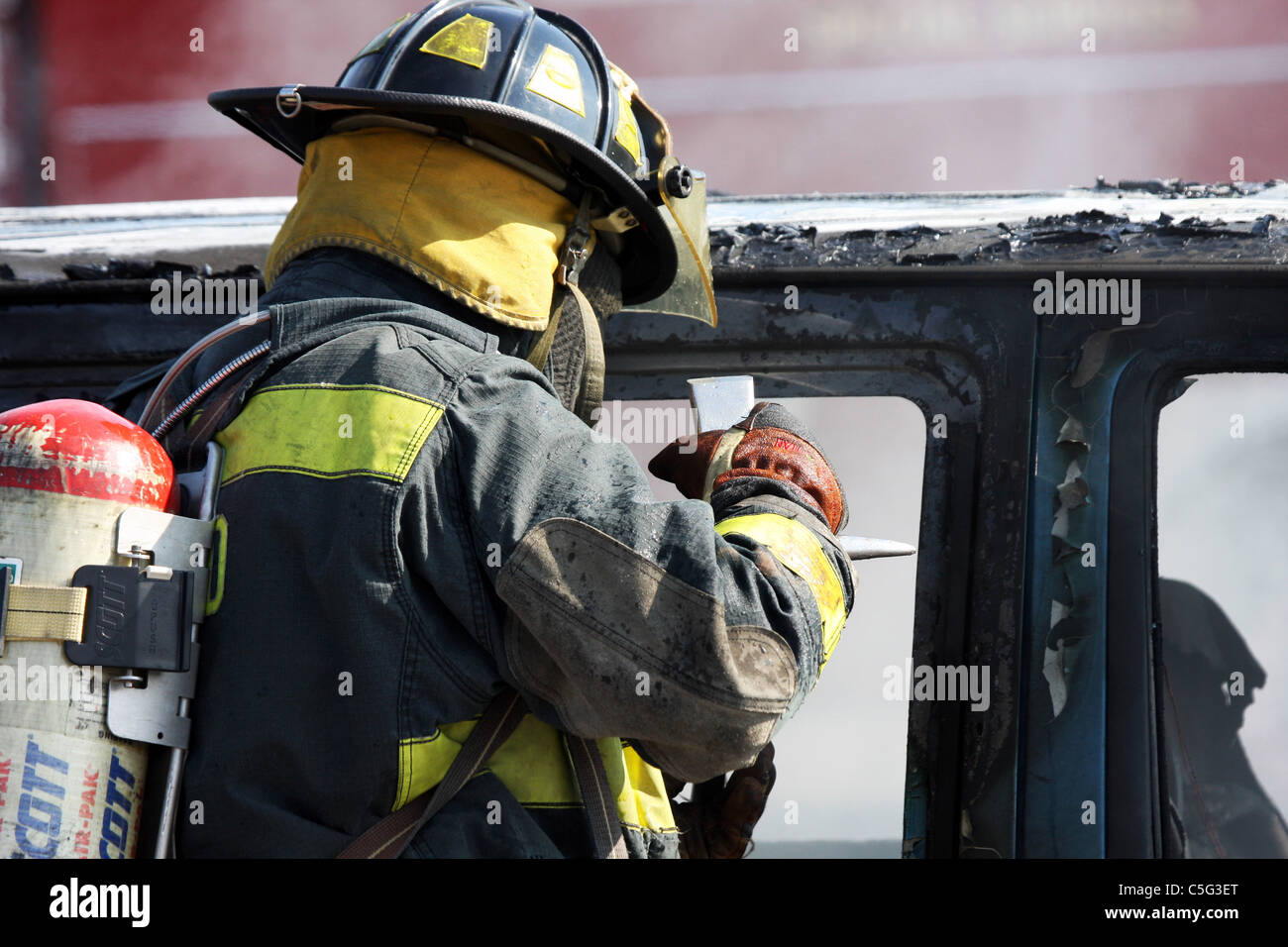 Fire fighter putting out a car fire Stock Photo - Alamy