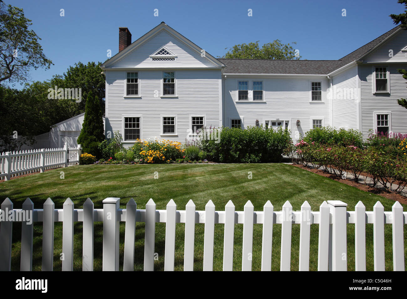White clapboard house and white picket fence in Hyannis on Cape Cod, Massachusetts Stock Photo