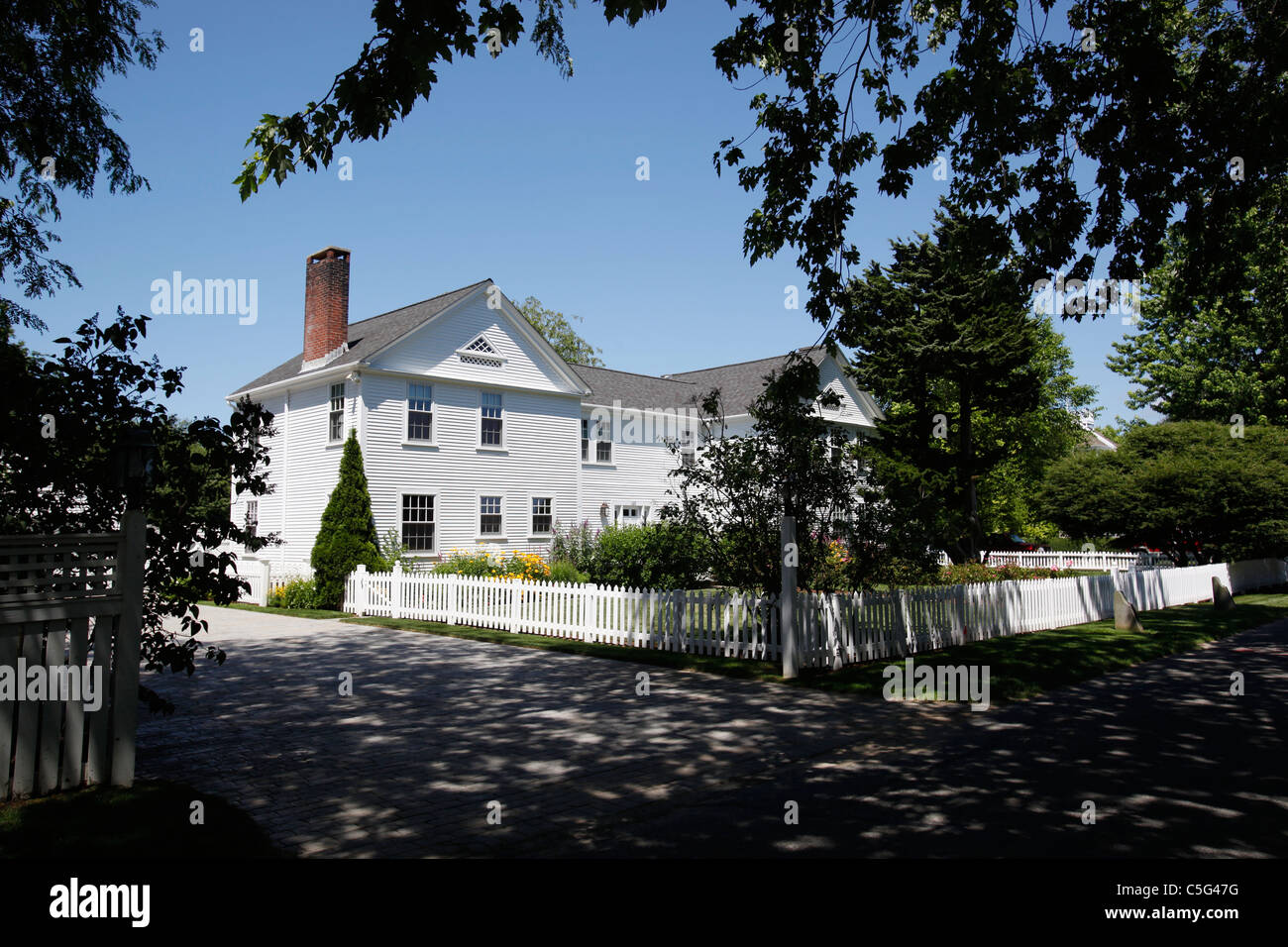 White clapboard house and white picket fence in Hyannis on Cape Cod, Massachusetts Stock Photo