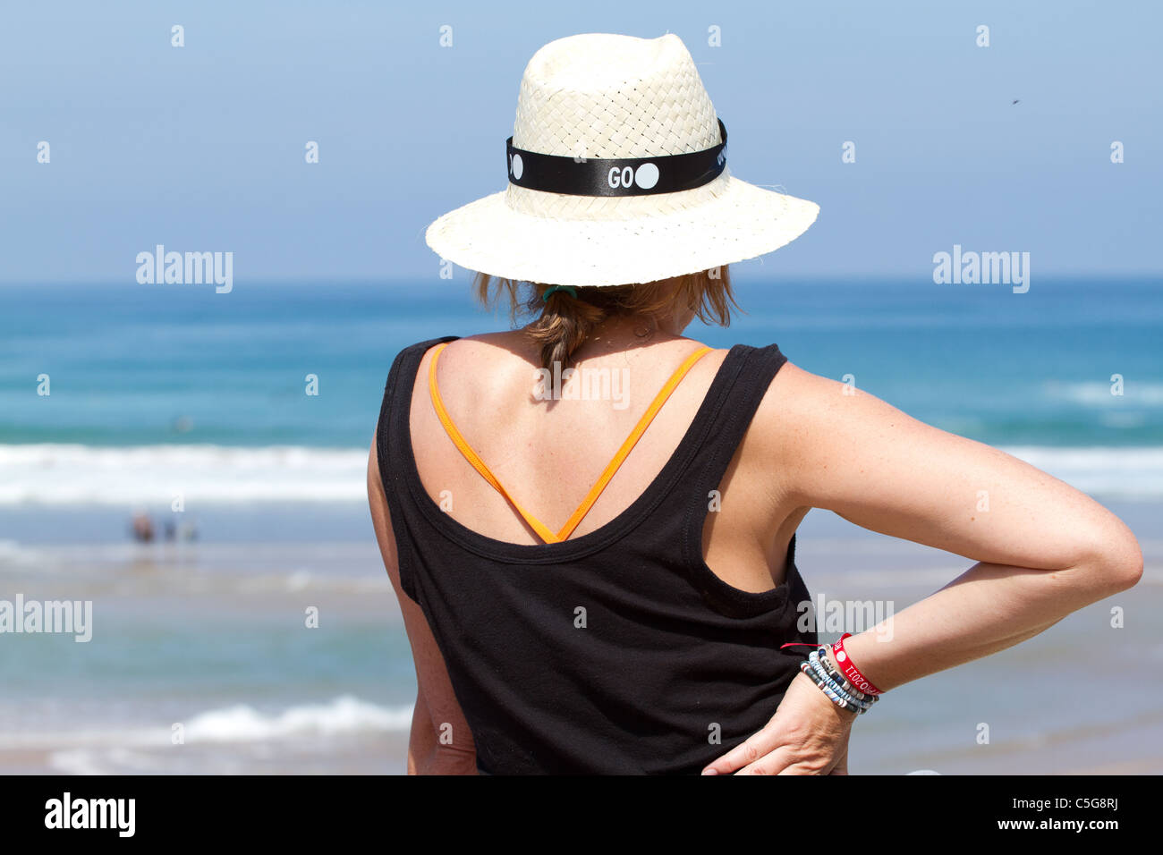 Woman on beach wearing a hat hi-res stock photography and images - Alamy