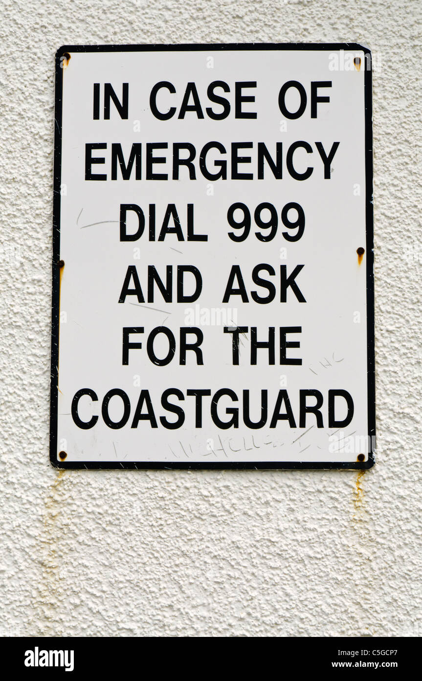 Sign 'In case of emergency dial 999 and ask for the coastguard' Stock Photo