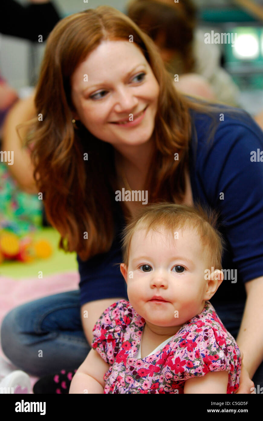 Mother with her baby in creche, Surrey, UK. Stock Photo