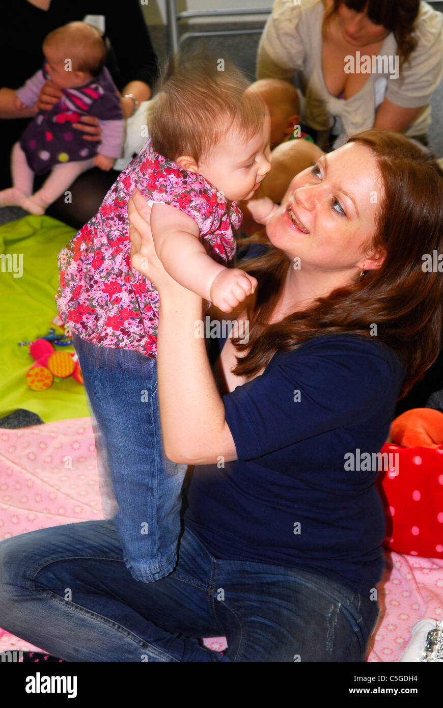 Mother with her baby in creche, Surrey, UK. Stock Photo