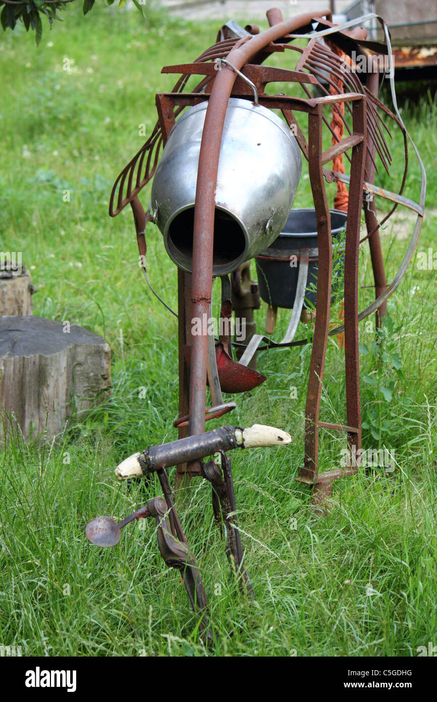 artwork of a rusty cow made from iron garden utensils , conceptual image , metaphor Stock Photo