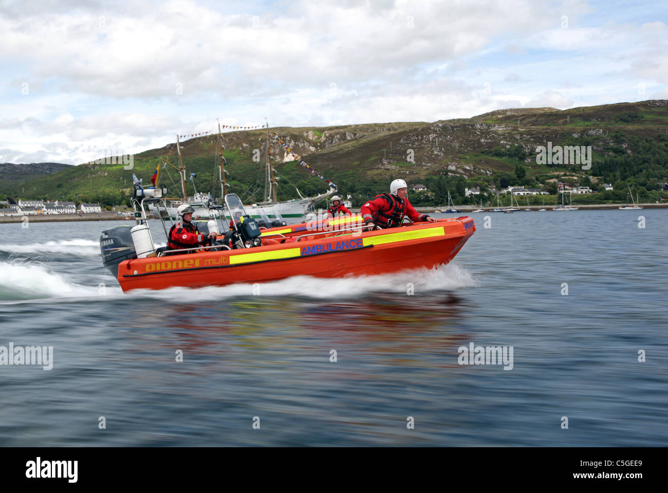 British Red Cross Ambulance fast rescue craft in action with crew aboard Stock Photo