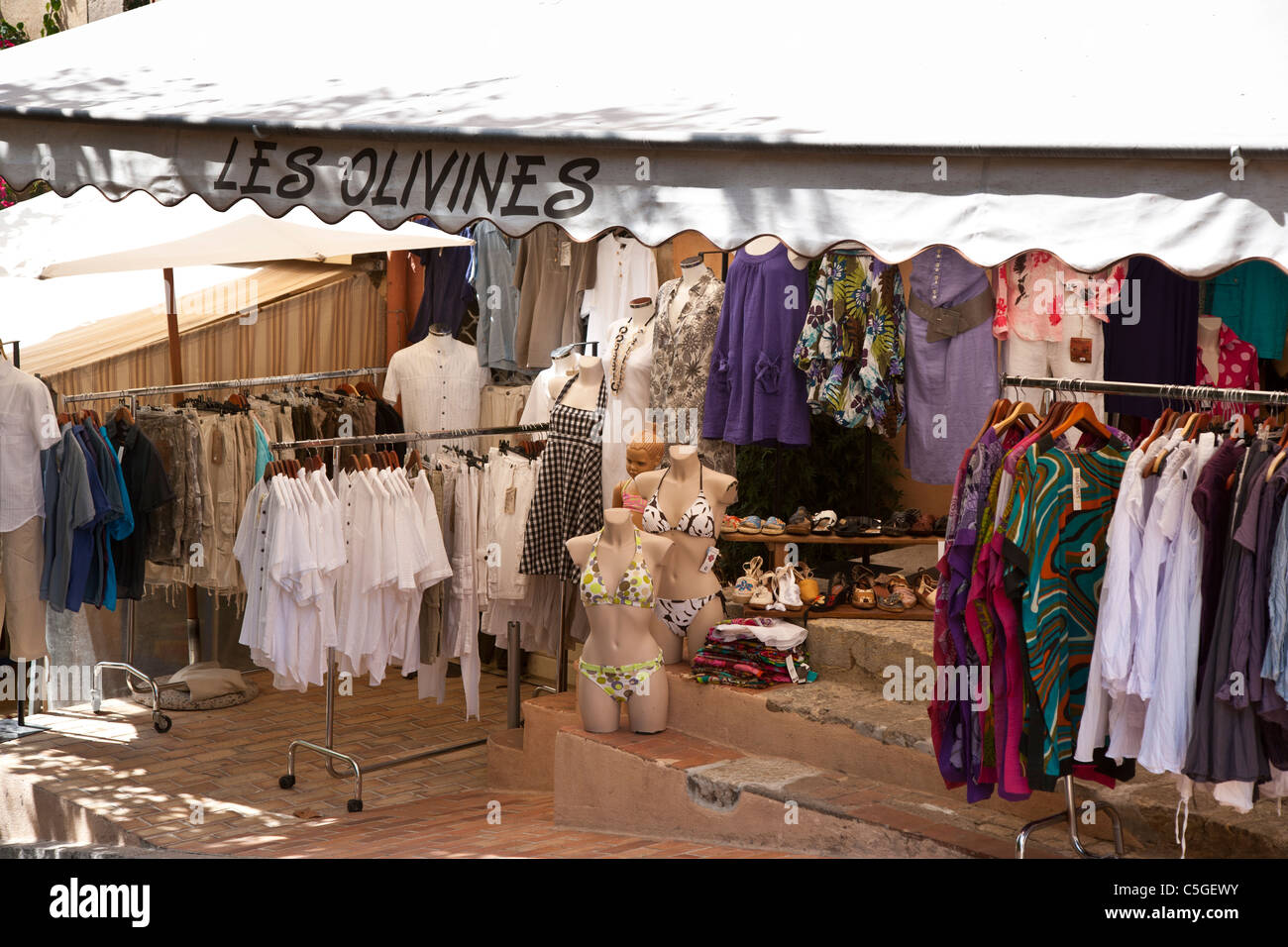 Clothes shop with outdoor display showing clothes on racks, Fayence, Provence, France Stock Photo