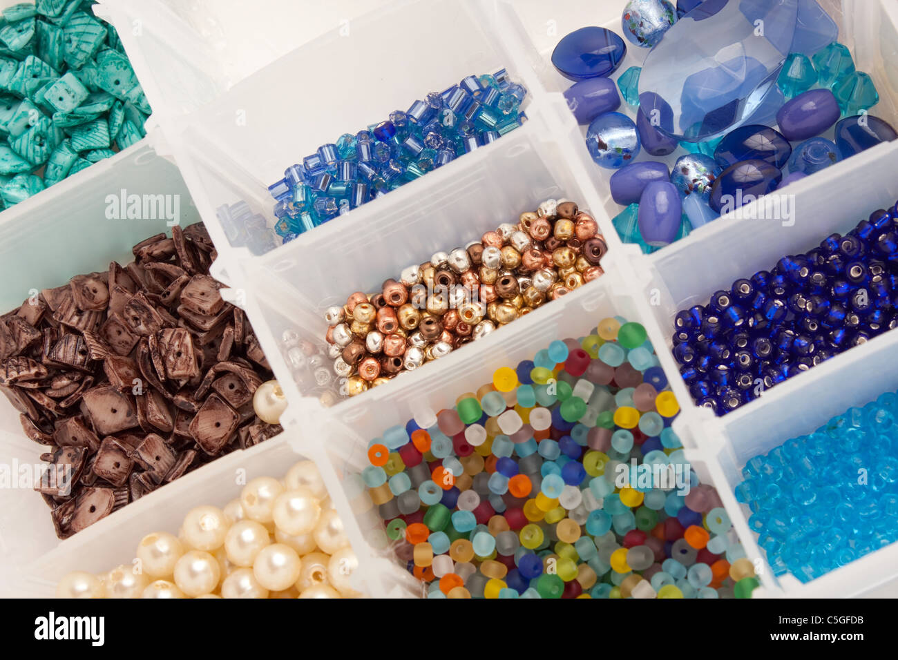 An organizer full of multi colored beads and tools for making jewelry and crafts. Stock Photo