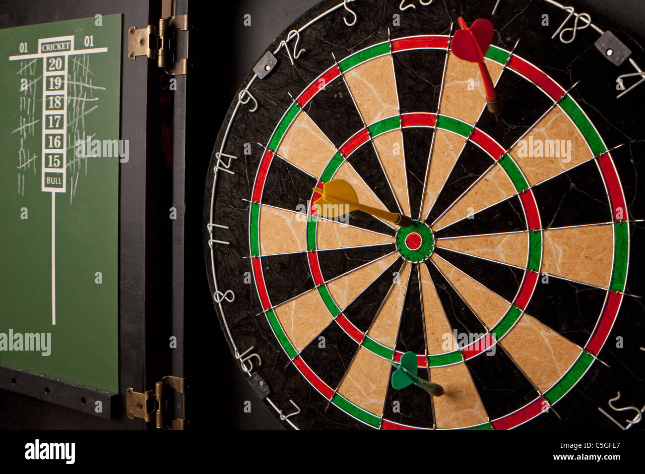 A professional dart board enclosed in a with slate chalkboard