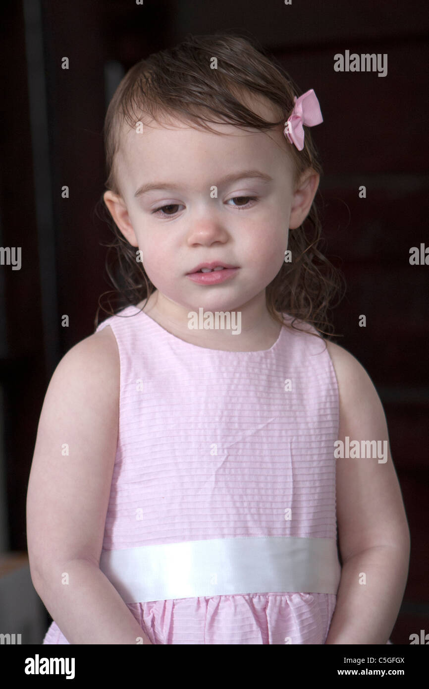 little girl with bow in a pink dress Stock Photo - Alamy