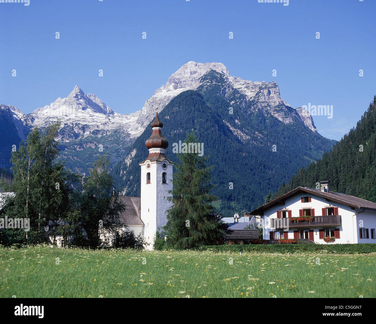 Our Lady of the Rosary Church and mountains, Lofer, Salzburg State, Republic of Austria Stock Photo