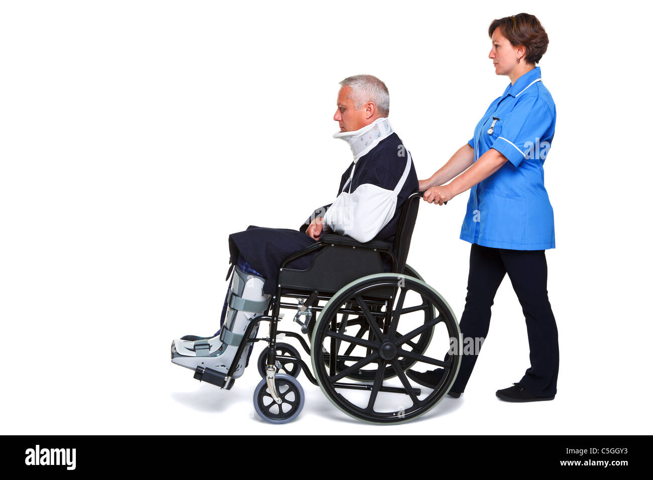 Photo of an injured man in a wheelchair with a female nurse pushing him, isolated on a white background. Stock Photo