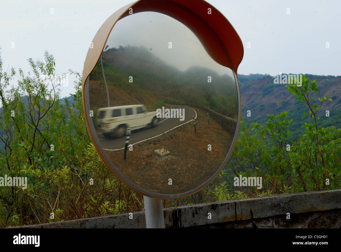 mountain turning road mirror Stock Photo