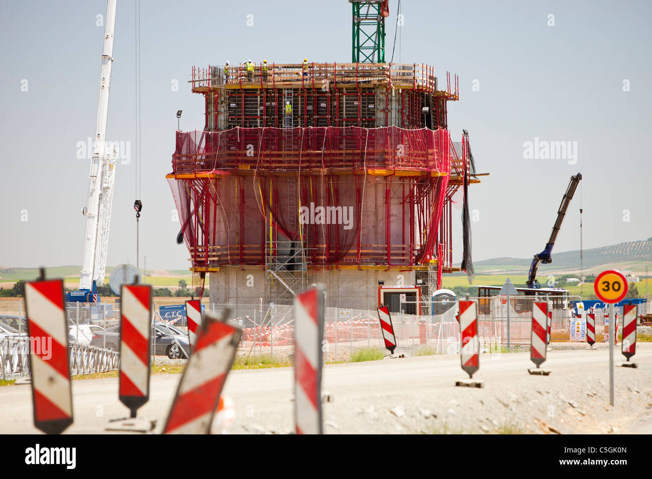 A new solar tower being constructed at the Solucar solar complex owned by Abengoa energy, in Sanlucar La Mayor, Andalucia, spain Stock Photo