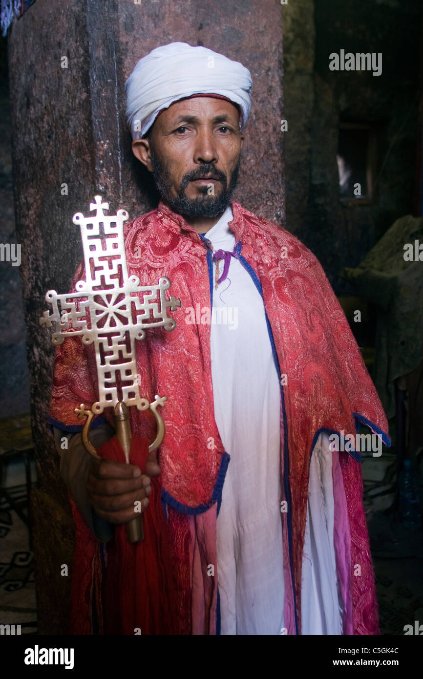 Priest in Bet Danaghel Church holding the Cross of King Lalibela. The  rock-hewn churches of Lalibela make it one of the greatest  Religio-Historical sites not only in Africa but in the Christian